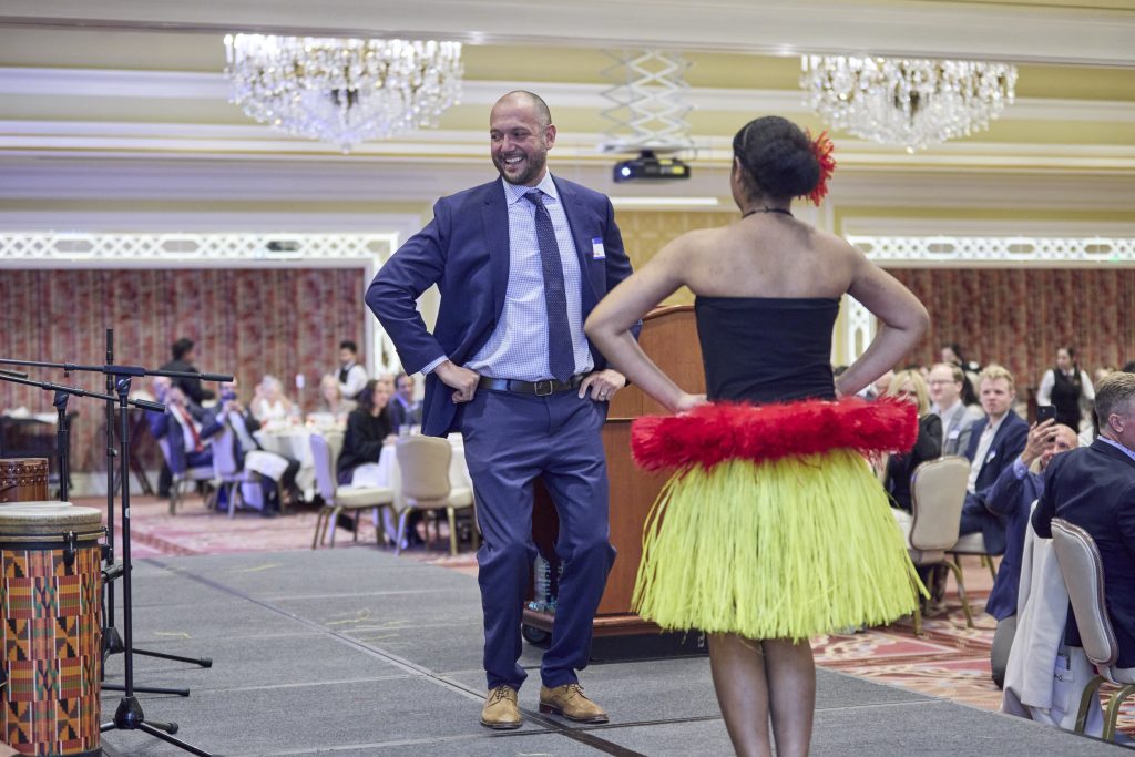 Matt Barraza dancing with a female performer in a musical performance at the 2024 UMBA Awards and Scholarship Banquet held at Little America Hotel