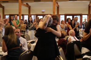 Prof. Jensie Anderson - Lifetime Service Award recipient - receives a big hug from her daughter at the 2025 Annual Meeting of the Utah State Bar